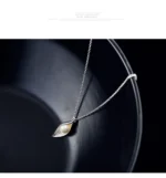ByQueen | Ασημένιο κολιέ Lumière Pearl Leaf με πέρλα σε μαύρη επιφάνεια